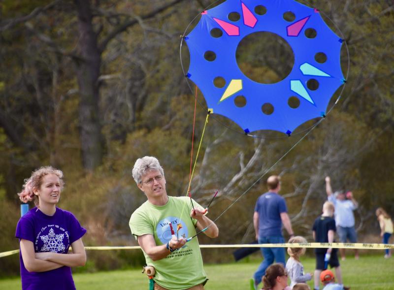 Rich Cairncross of Media, Pa., gives his daughter, Chloe, a lesson in kite flying. Rich won top honors in the high-flying contest, most attractive homemade kite and best flyer of a homemade kite.