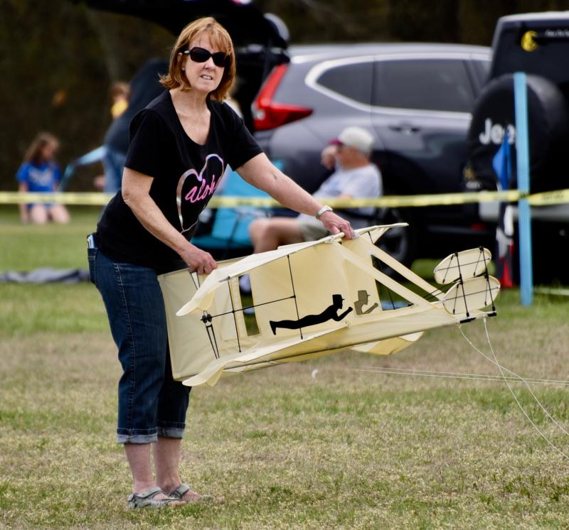 Renie Niemkiewicz of Lewes helps her husband, John, get a unique Wright Brothers airplane kite off the ground.