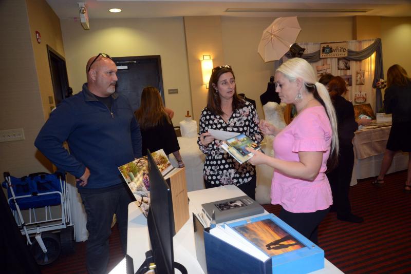 One of several photographers at the expo was Andrew Nock Photography from Salisbury, Md. Shown are Nock, Kim Nock, and Jennifer Girouard. Bridal Expo