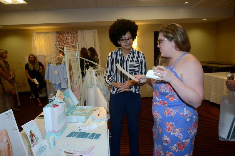 Getting some information from Something Comfortable is Sarah McMillan, left, and fitter Janetta Green. Bridal Expo