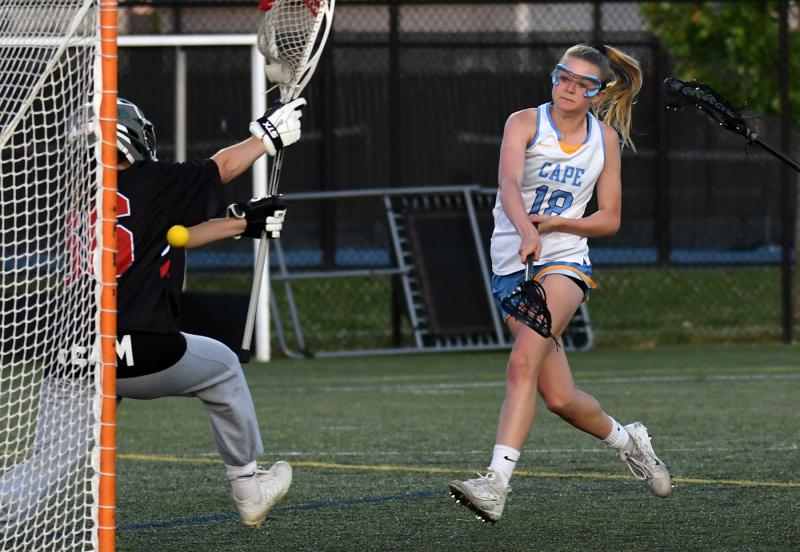 Cape junior midfielder Meredith Lockwood shoots and scores past Ursuline goalie Brigid Monahan in the 18-11 victory. She scored six goals in the contest. DAN COOK PHOTOS