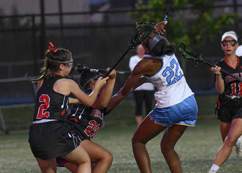 Cape attack Sawyer Walker, right, takes a stick to the head and a cross check from Ursuline’s Sophia Shroyer, left, and Jordan Baerga.