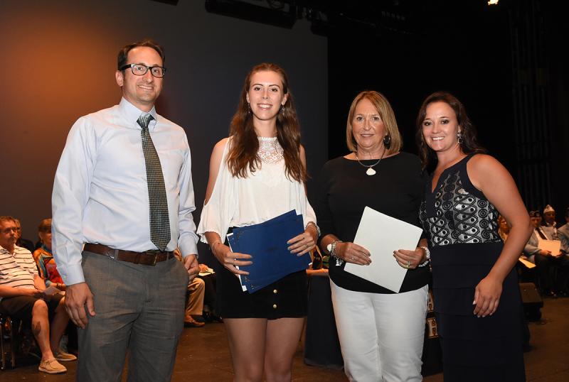 Celebrating student honors are (l-r) Mike DiPaolo of Delaware Community Foundation, student Macy Beach, Debbie Russo of Daughters of the American Revolution, and Cape Principal Nikki Miller.