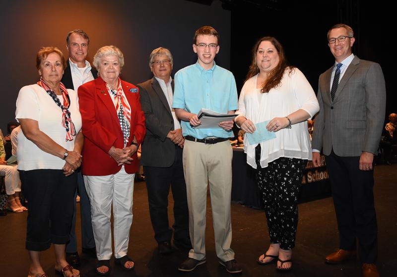 Dylan Carnright, center, is shown with (l-r) Gail Sellazzo and MaryAnn McCrea of American Legion Auxiliary Post 17 William T. Spooner Scholarship, Cape Superintendent Bob Fulton and Robert Starky of Milford Rotary in back, Mary Ellen Kiernan of the James Kiernan Memorial Scholarship and Dr. Jonathan Johnson of Johnson Orthodontics.