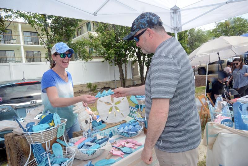 Meghan McCalley, of Meghan’s Collection, shows her local beached-themed crafts to Ron Alexander from Rehoboth Beach. DBP Arts Fest
