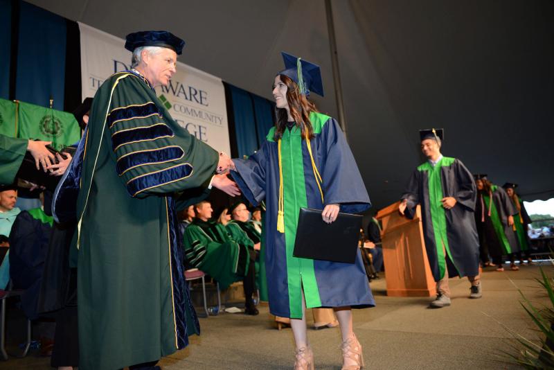 Alona Katerychuk from Rehoboth Beach gets a congratulations from President Mark Brainard for earning her accounting degree. Del Tech Commencement