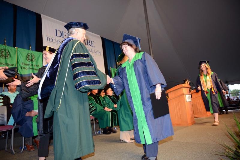 Nancy Lyons from Millsboro earned her degree in management. Lyons is shown shaking hands with President Mark Brainard after getting her diploma. Del Tech Commencement