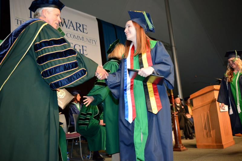Samantha Morse from Georgetown smiles as she shakes hands with President Mark Brainard after getting her diploma. Del Tech Commencement
