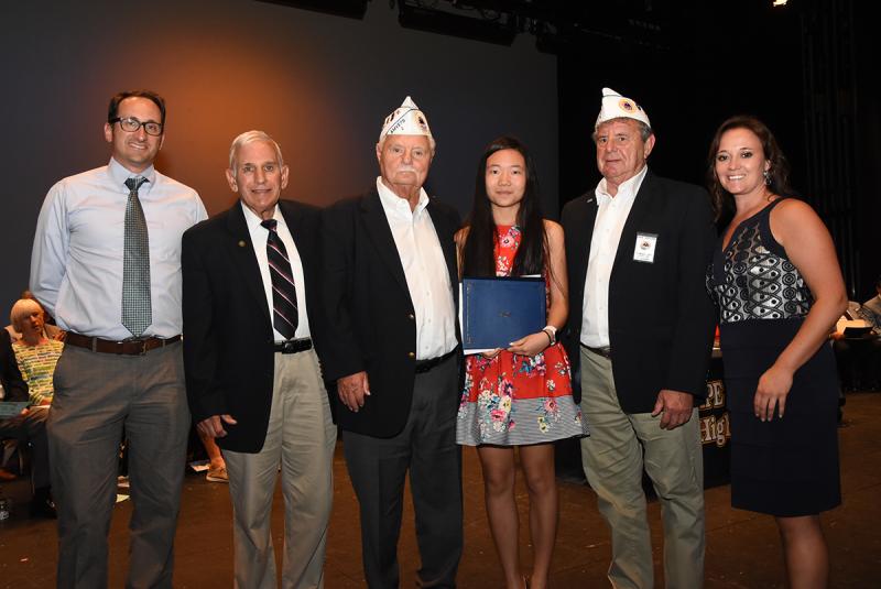 Yuxin He is shown with (l-r) Mike DiPaolo of Delaware Community Foundation, Col. Ronald Erale, Tom Jones and Dave Heffline of Sussex AmVets Post 2, and Cape Principal Nikki Miller.