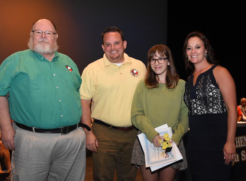 Zoe O'Neill-Chapman accepts her award with (l-r) Dickie Mitchell and Christopher Berg of Rehoboth Beach Bears, and Cape Principal Nikki Miller.