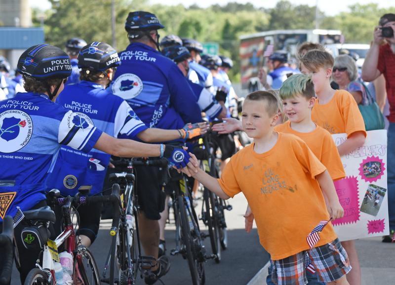 Welcoming the Police Unity Tour to Lewes are Lil Long Neckers (l-r) Austin Brown, Dylan Stockley and Teresa Fritts.