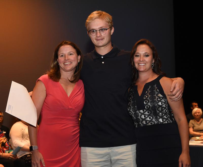 Cayden Steele accepts his award with Dr. Amy Robinson of the David and Linda Robinson Scholarship and Cape Principal Nikki Miller.