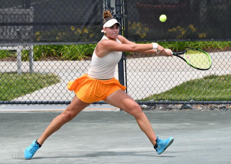 Maria Mateas stretches out for a shot in her match with Katerina Stewart. She was forced to retire in the third set due to illness.