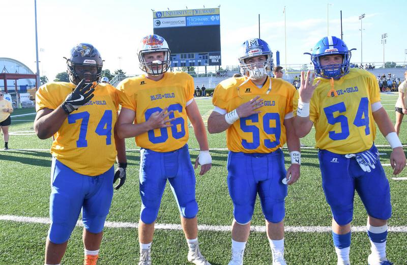 Gold players (l-r) Ahmir Gibson of Appoquinimink, Austin Mendes of Cape, Joshua Propes of Woodbridge and Cade Krueger of Middletown honor teammate Troy Haynes.