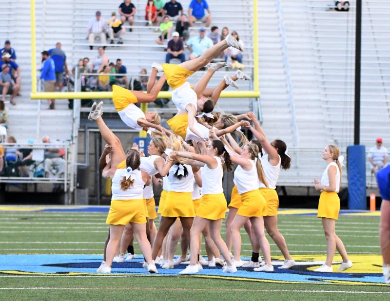 The Gold cheerleaders finish up a tough stunt.