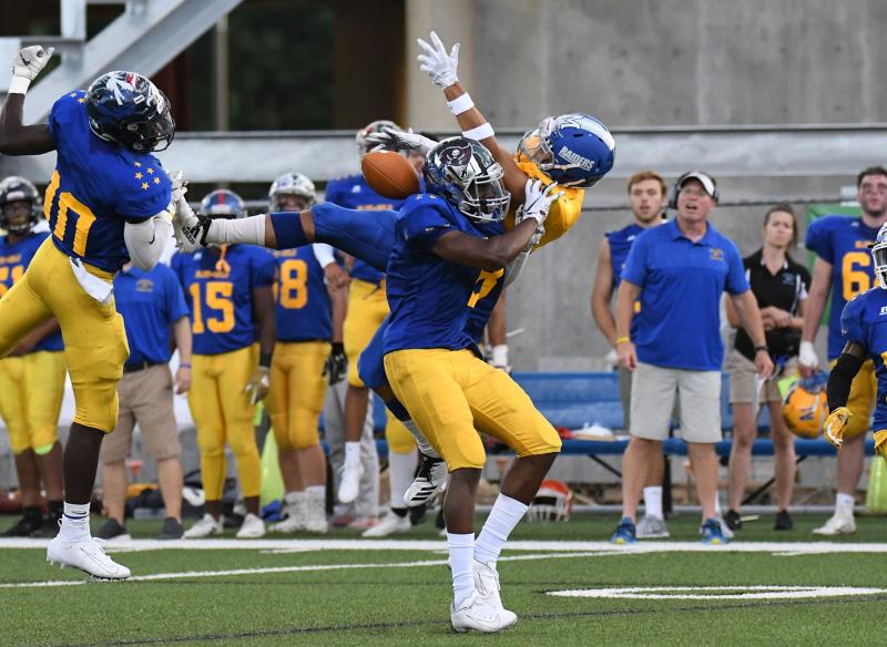 Gabe Wescott, right, from Woodbridge has a catch broken up by Daniel Douglas of Hodgson Vo-Tech.