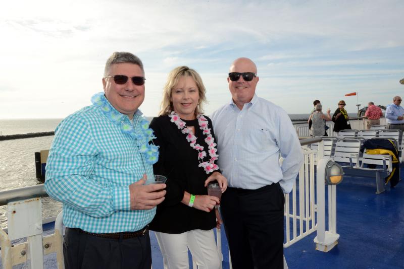 Relaxing on the deck away from the wind are (l-r) sponsor Mark Cooper, Beebe Healthcare Chief Human Resources Officer Katie Halen, and sponsor Shawn Marvel. Beebe Beach Bash