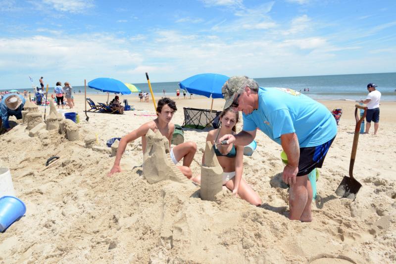 Volunteer and veteran sandcastle builder Andy West gives some pointers to Mac Koopman and Athena Gorgelas. Longest Sandcastle