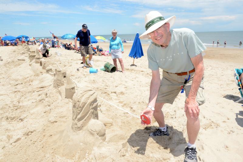Dewey Beach Infrastructure member Jim Tyler showed up to measure the castle. He announced “101 feet.” Longest Sandcastle