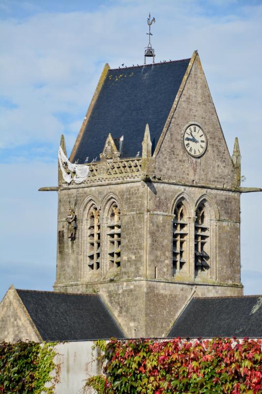 A mannequin paratrooper depicts the fate of American John Steele who was trapped on the bell tower of the church in Sainte-Mere-Eglise, one of the first French towns liberated. He was taken prisoner, escaped and survived the war.