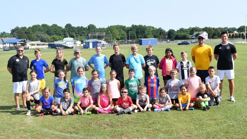 The Henlopen Soccer Club elementary soccer camp included in back (l-r) coach Patrick Kilby, Harrison Dabbs, Olivia Dabbs, Madison Layfield, Sara Kilby, Braxton Figgs, Quinton Eisenmann, Gavin Issacs, Yuvia Velasquez, Andrew Warrell and coaches Scott Bleile and Joe Rupar. In middle are Max Ruggerio, Ellery Gerth, Olivia Tarr, Audrey Hershelman, Vivian Ruggerio, Quinn Lobley, Ryker Christensen, Aydin Pusey, Sally Christensen and Ben Hill. In front are Elizabeth Downer, Malec Ksebe, Zachary Wexler, Addyson Bleile, Luke Riley, Ben Rodriguez, Olivia Hershelman, Tejal Pillai and Abby Cunningham. DAN COOK PHOTOS