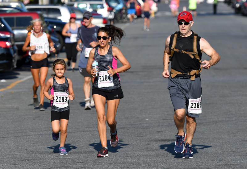 The family that runs together finishes together; shown (l-r) are Mia, Jeannie and Eric Vasquez ending with a 38:39.