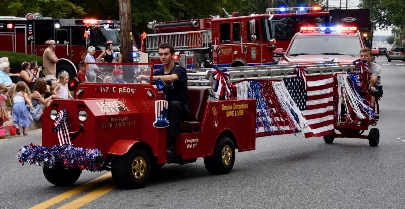 Driving the Lewes Fire Department Little Reds are firefighter Stephen Metler, front, and junior firefighter Jake Hunsicker.