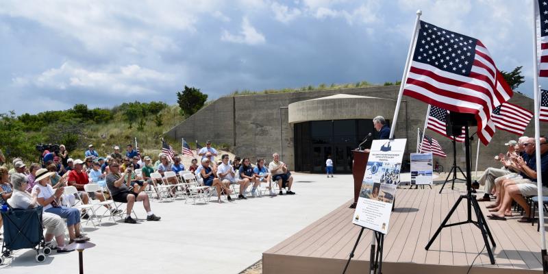 A large crowd attends the July 11 Great Dune Overlook dedication ceremony in front of Battery 519 and the Fort Miles Museum.