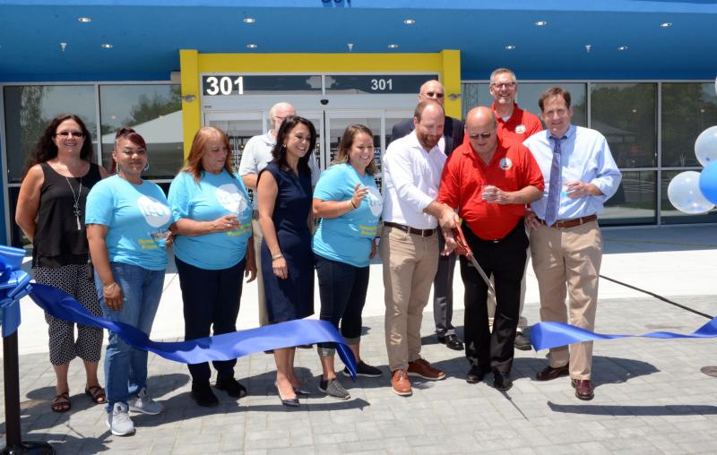 Cutting the ribbon in front of the new ONIX Group Tru by Hilton are in back (l-r) Steve Silver, County Council President Mike Vincent and Georgetown Town Manager Gene Dvornick. In front are Georgetown Council Rebecca Johnson-Dennis, Assistant Manager Chelsea Johnson, General Manager Camille Passalacqua, Global Head Tru by Hilton Talene Staab, ONIX Hospitality Vice President of Operations Jennifer Coverdale, Vice President ONIX Group Jonathan Silver, Georgetown Mayor Bill West, and ONIX Group Vice President of Real Estate Dean Pletz. ONIX Group Tru by Hilton