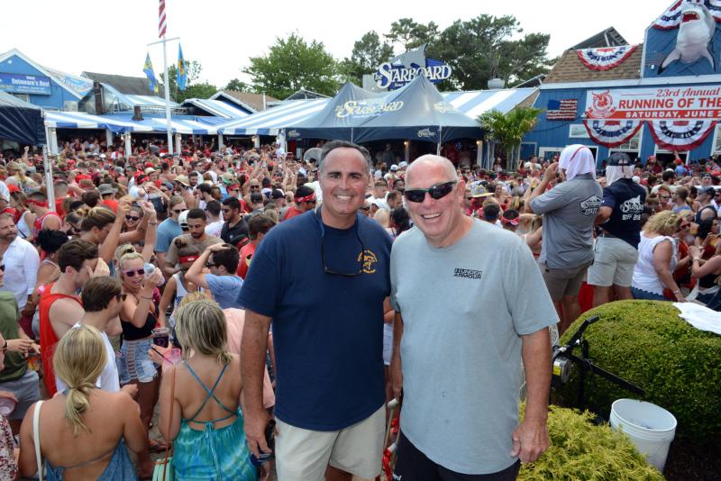 Staying above the revelers in The Starboard parking lot are Sen. Ernie Lopez. R-Lewes, and Rep. Pete Schwartzkopf, D-Rehoboth Beach. Running of Bull 2019