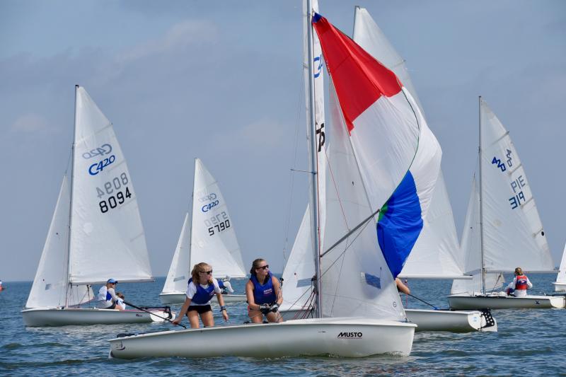 Club 420 sailors Skylor Sweet and Isabella Webb of North East River Yacht Club in North East, Md., raise their spinnaker as they round a mark. They finished third overall.