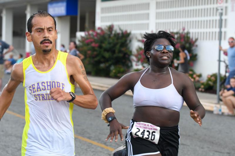 Martin Rodriguez provides coaching assistance for Selex Horsey in her first 5K. DAVE FREDERICK PHOTO