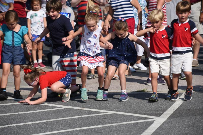 One youngster takes a fall as she begins the three-legged race.