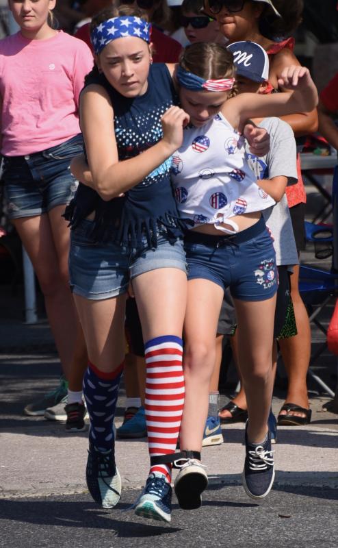 Cassie O’Neill, left, and Korin Eddirolano sprint to a win in the three-legged race.