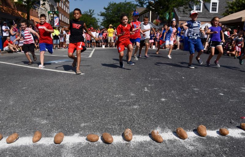 Racers approach the line to grab a spud in the potato relay.