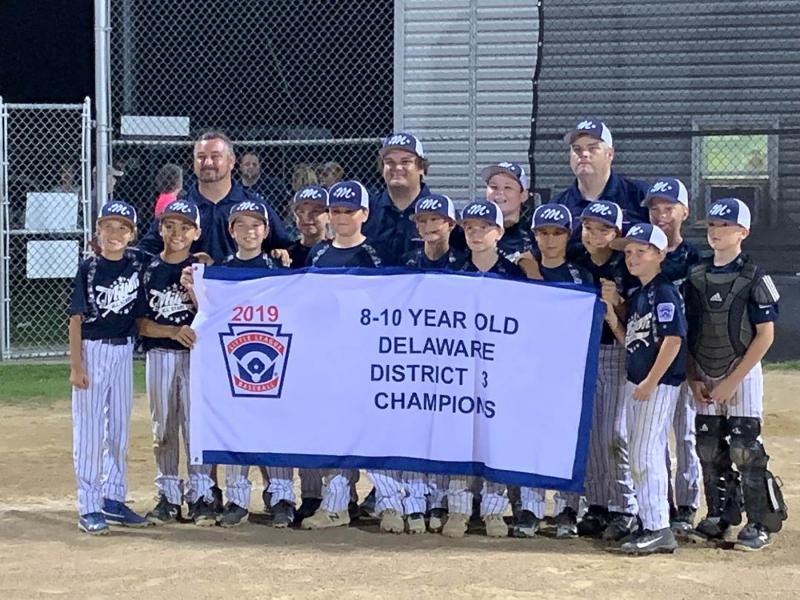 Posing with the District 3 banner are in back (l-r) manager Tony Willey, and coaches UJ Johnson and Ukie Johnson. In front are Austin Guerrieri, Jordan Williams, Liam Mitchell, Logan Smith, Ryan Coulbourne, Trey Dickinson, Aaden Johnson, Dominic Mangini, Trig Joseph, Mason Glover, Trizton Willey, Harper Kaser and Andrew Connors. SUBMITTED PHOTO