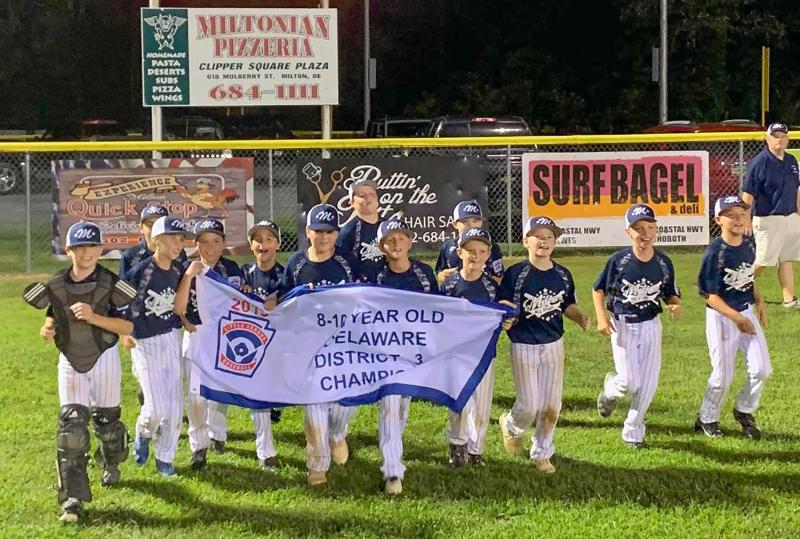 The Milton 8-10 All-Stars take a victory lap around Dr. Tobin Field with the District 3 banner. Shown are (l-r) Andrew Connors, Austin Guerrieri, Jordan Williams, Liam Mitchell, Trig Joseph, Ryan Coulbourne, Dominic Mangini, Trey Dickinson, Trizton Willey, Logan Smith, Aaden Johnson, Harper Kaser and Mason Glover. SUBMITTED PHOTO