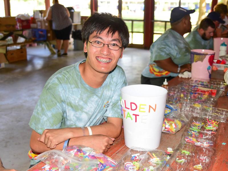 SODE athlete and Golden State Warriors fan Asa Mebane makes a colorful storage can during arts and crafts.