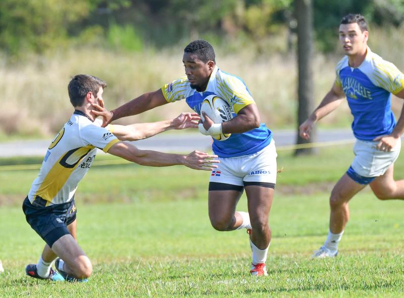 Former Cape Vikings running back and University of Delaware rugby club player Justin Lopez stiff-arms an Arbutian Revolution defender and runs for a score. DAN COOK PHOTOS