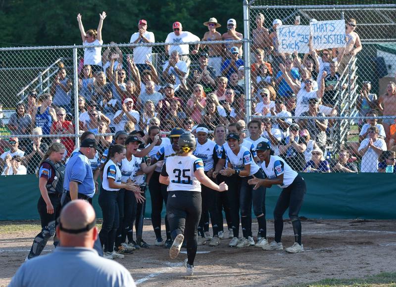 The District 3 squad along with their fans in the stands welcome Kate Evick after her home run in the seventh inning.