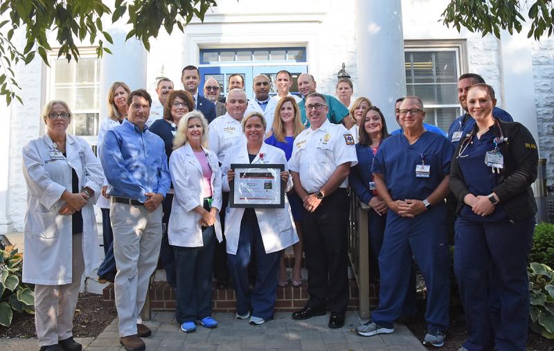 With the Mission: Lifeline Silver Receiving Quality Achievement Award are in back (l-r) Rob Murray, Sussex EMS; David Morris, executive director, Delaware chapter of the AHA; Rick Schaffner, interim president and CEO, Beebe; Jonathan Kirch, advocacy director, AHA; Dr. Ehtasham Qureshi, cardiologist and stroke/heart team; Jordan Datoli, Sussex EMS; Dr. Abraham Scheer, neurohospitalist and stroke/heart team; Glen Marshall, Sussex EMS. In middle are Michele Seiler; Susan Mross, emergency services, stroke/heart team; Bob Stuart, Sussex EMS; Tawny Jackson, director of quality and systems improvement, AHA; Mary Frances Suter, executive director of cardiac & vascular services; and Steven Rhone, VP and chief nursing officer. In front are Christina Lewis, director of nursing; Dr. Kevin Bristowe, emergency services physician; SueAnn Newsham, nurse manager; Loretta Ostroski, director of patient care services; Rob Mauch, Sussex EMS; Colleen Alton; Cary Rutherford, transport coordinator, Beebe; and Julie Short, ENIT.