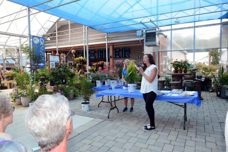 Spring Meadows Nursery Account Manager Kimberly Noffke, right, talks about an Arborvitae Fluffy produced by Proven Winners, as ECGC owner Valerie Cordrey helps answer questions. Brews, BBQ and Bushes
