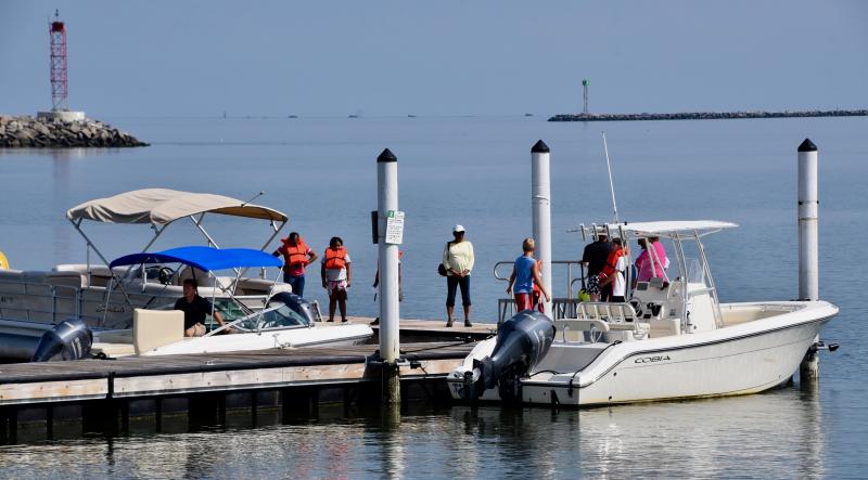 Freedom Boat Club staff show their boats to children in the Big Brothers, Big Sisters program from Sussex County.