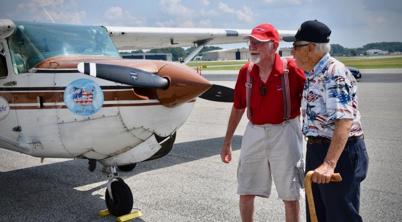 Like old friends, John Billings, left, and Tom Creekmore share stories as they meet for the first time.