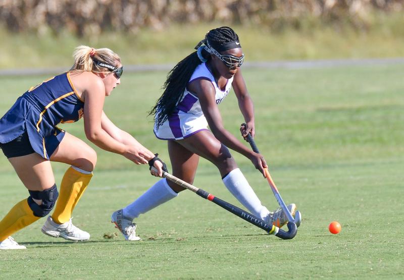 Delmarva Christian’s Melisa Pierre-Louis, right, moves the ball upfield against the tough defense of Holly Grove’s Cassidy Merrill.