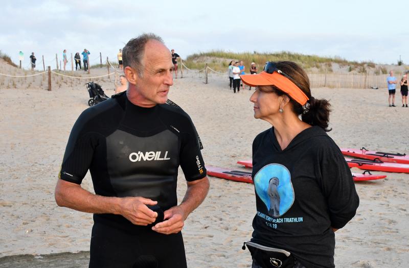 Delaware State Parks Beach Patrol Capt. Kris Knutsen informs race director Ava Cannon of the dangerous suff conditions.