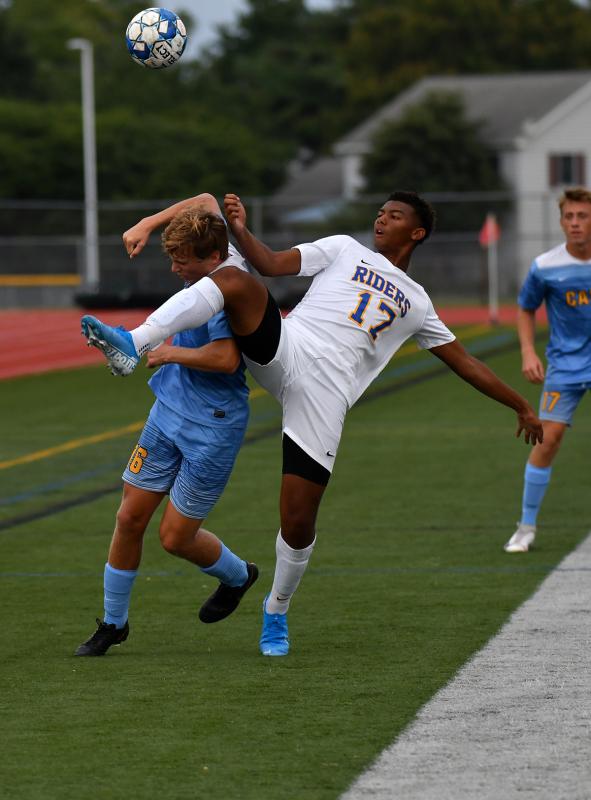 Cape junior Nathan Loucks, left, takes a high kick from Caesar Rodney’s Monroe Hite on the sideline.