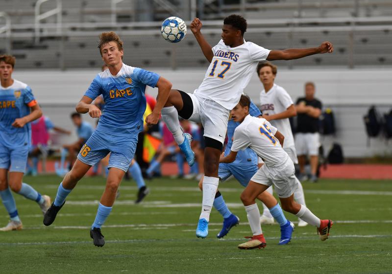 Cape junior Nathan Loucks, left, battles with Caesar Rodney’s Monroe Hite in the Riders’ 4-0 win over the Vikings. DAN COOK PHOTOS