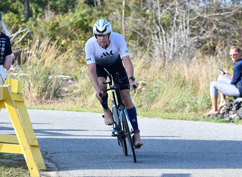 Cameron Hamilton rolls in first in the bike leg of the Dewey Beach Sprint Triathlon. He completed the bike leg in 38:44 and took top honors overall with a time of 1:03.59. DAN COOK PHOTOS