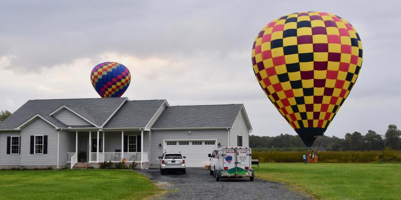 Some teams didn’t fly very far due to the humid weather. Wonderful Whirled balloon from Goldbloom, Pa., and Yellow Jacket balloon from Chester, Md., land along Shingle Point Road near Georgetown.